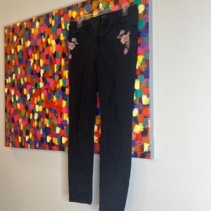 Black jeans with floral print and distress look